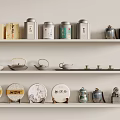 Elegant Tea Set Display with Teapots Canisters and Decorative Tea Cakes on Shelves