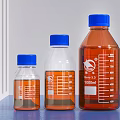 Medical Laboratory Bottles With Blue Caps Different Sizes Graduated Transparent And Brown