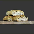 Golden Pastry Pieces Stacked On Wooden Cutting Board For Serving