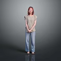 Woman in Light Colored Top and Blue Jeans Standing Against Gray Background
