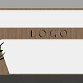 Modern Wooden Interior Wall With Engraved Logo And Green Plant Decor