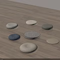 Various Soft Round Fabric Cushions In Different Colors On Wooden Floor
