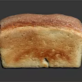 Freshly Baked Golden Crust Bread With Soft Interior On Black Surface
