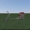Mobile Agricultural Irrigation Equipment With Red Reel And Wheels On Green Field