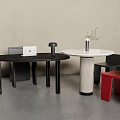Modern Black Desk With Round Side Table Red Chair And Decorative Vase