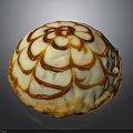 Round Dessert With Creamy White Frosting And Caramel Floral Pattern On Almond Crumb Base