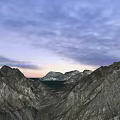 Scenic Garden Landscape With Snow Covered Mountains Calm Lake And Sunset Sky