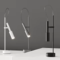 Three Modern White and Black Desk Lamps Featuring Two Lit Stylish Contemporary Design