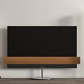 Modern TV With Wooden Stand And Floor Standing Speakers In Minimalist Interior