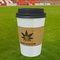 AmeriCanna Cafe Paper Cup Beverage With Marijuana Leaf Sleeve On Green Grass Field