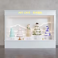Art Cake Window Display With White Illuminated Showcase And Multi Tier Decorated Cakes