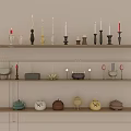 Various Decorative Candles and Unique Candle Holders Displayed on Wooden Shelves