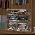 Clothes Neatly Stacked In Closet With Metal Grid Storage Rack And Various Colors