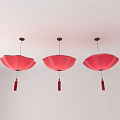 Three Red Petal Shaped Chandeliers With Tassels Hanging From White Ceiling