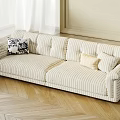 Striped Three Seater Sofa With Patterned And Beige Cushions On Wooden Herringbone Floor