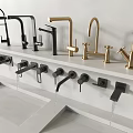 Modern Black And Gold Faucets On White Countertop With Flowing Water