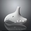 White Ceramic Ocarina Musical Instrument With Multiple Sound Holes And Shiny Reflective Surface