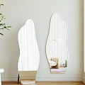 Irregular Shaped Decorative Mirrors With Vertical Lines On Light Wall Reflecting Chair And Lamp