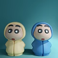 Two Yellow and Blue Dolls in Hooded Outfits with Surprised Expressions
