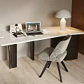 Elegant Modern Desk With Marble Top Laptop Books Photo Frame And Comfortable Gray Chair
