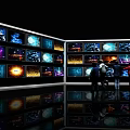 Multiple TVs On Display Wall With People Watching Colorful Dynamic Visuals