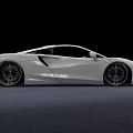 White Sports Car With Sleek Aerodynamic Body And Large Alloy Wheels