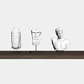 White Decorative Sculpture Ornament Set On Wooden Shelf With White Wall Background