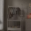White Clothes Rack With Hanging Coats T Shirts And Pants Near Drawer Cabinet Lamp Vase
