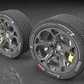 Two Modern Automotive Tires with Alloy Wheels and Detailed Tread Design