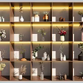Various Decorative Vases With Different Flowers On Multiple Lighted Display Shelves