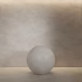 Light Gray Rough Textured Wall With Light Gray Sphere On Light Colored Tabletop