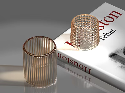 Transparent Glass Cups With Striped And Grid Patterns Placed On Magazine 3d model