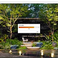 Modern Courtyard Garden With Waterfall Wall Trees Lush Plants Comfortable Chair And Warm Lighting