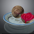 Fresh Whole And Cut Beetroot With Vibrant Red Flesh On A Plate