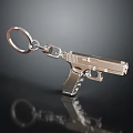 Elegant Silver Metallic Pistol Shaped Jewelry Keychain on Black Surface with Shiny Reflection