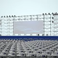 Concert Stage With Blue Lighting Large LED Screen And Audience Seats