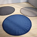 Woven Round Rugs in Dark Gray Light Gray and Blue on Wooden Floor