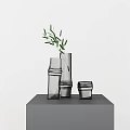 Glass Vases With Olive Branch In Various Shapes On Gray Pedestal