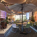 Cozy Casual Lounge Area With String Lights Umbrella Gray Walls Plants And Pebble Floor