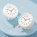 White Alarm Clocks Featuring Blue And Orange Details On Light Blue Background With Bubbles