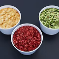 Three White Bowls of Colorful Food with Red Green and Yellow Textures