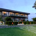 Modern Detached Villa With Large Glass Windows Lush Greenery And Lawn
