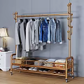 Golden Metal Clothing Rack With Hanging Shirts Jeans Folded Clothes And Shoes In Bedroom