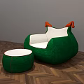 Green Armchair With White Cushion Orange Armrests And Matching Ottoman On Herringbone Wooden Floor
