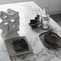 Decorative Ornament Set With White Spiral Sculpture Black Diffuser And Metal Tray On Marble Countertop