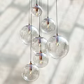 Transparent Glass Globe Pendant Lights With Multiple Hanging Design And Warm LED Bulbs