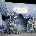 Elegant Photo Spot With Light Blue Arch Curtains And Blue White Floral Decorations