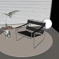 Modern Metal Frame Leisure Chair with Black Seat Small Round Side Table and Green Plant