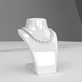 Elegant Pearl Necklace On White Jewelry Display Stand With White Countertop And Gray Background