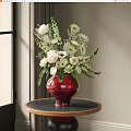 Red Glazed Vase with White Blooms and Greenery on Round Wooden Table in Interior